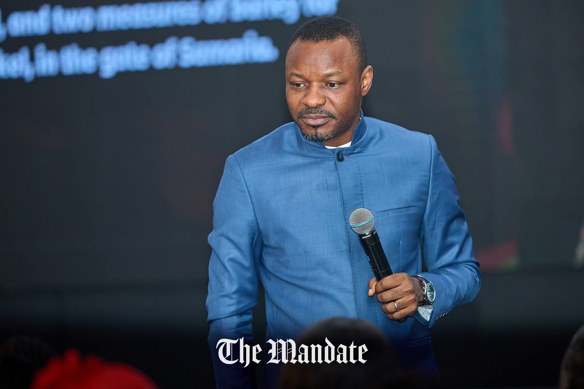H.E. Dr. E. Paul Mbuagbor teaching on stage — The Mandate broadcast